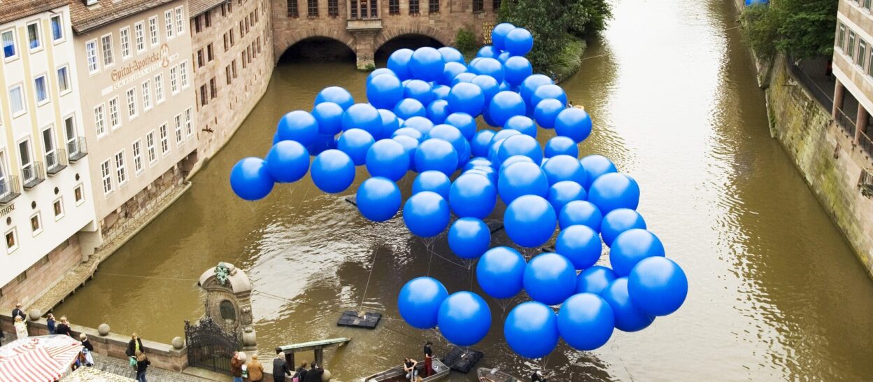 Blue balloons above the river Pegnitz by rosalie